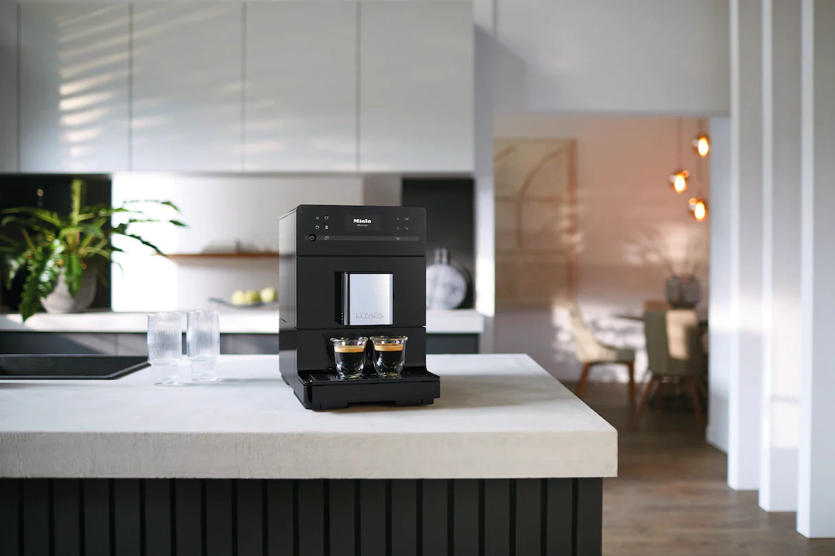 Miele bean-to-cup espresso machine brewing fresh coffee on a modern kitchen counter